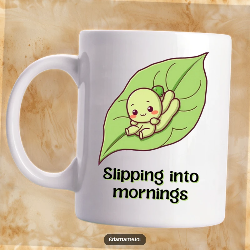 Funny mug featuring a cute, smiling edamame character gleefully sliding down a large green leaf, embodying playful joy.