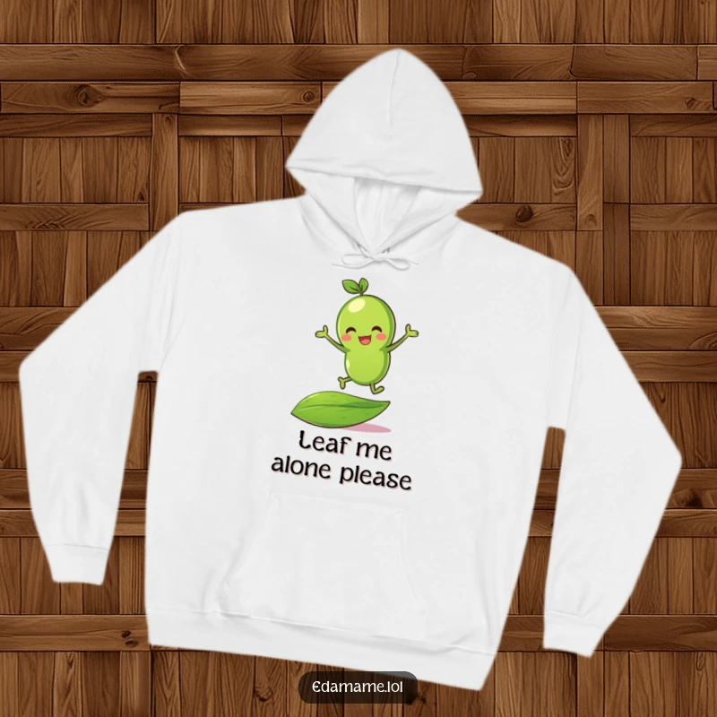 Funny green bean character animatedly bouncing on a leaf, depicted on a soft, comfortable hoodie.