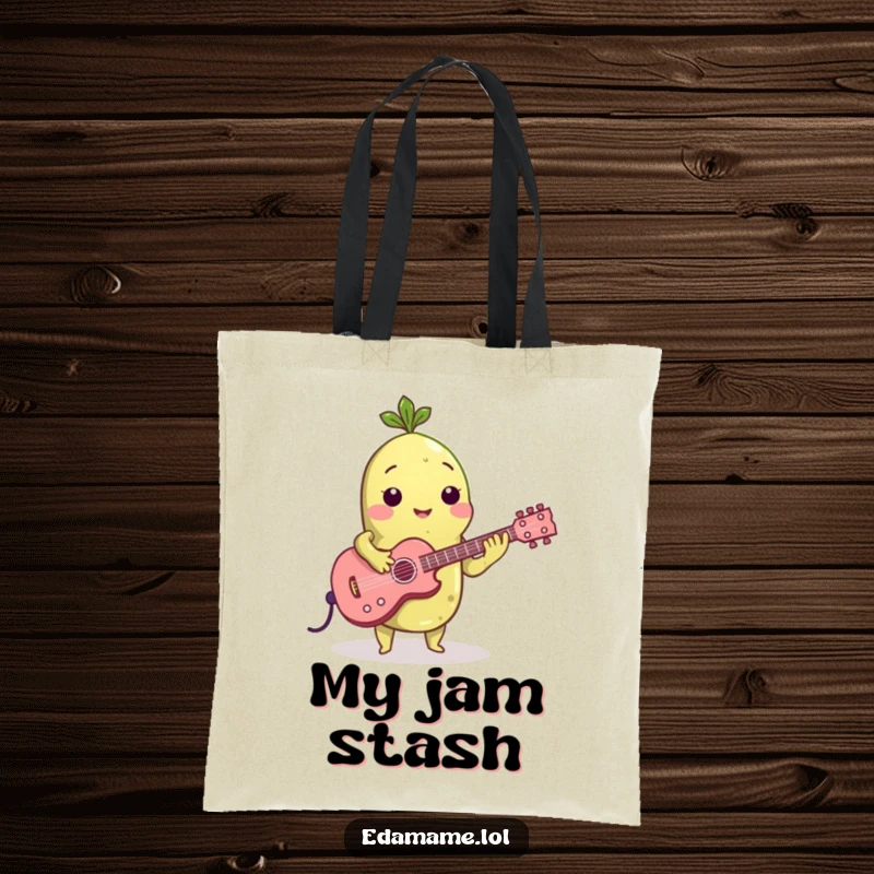 Funny tote bag showcasing an edamame bean playing a miniature guitar, perfect for carrying music accessories or everyday items with flair.